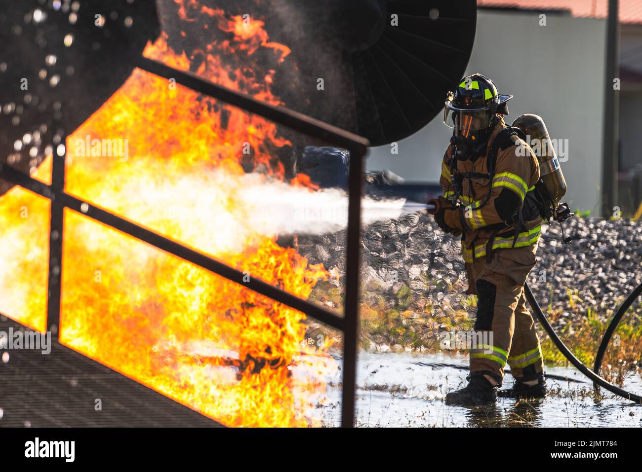 U.S. Air Force Airman Daniel Griffin, 6th Civil Engineer Squadron firefighter, puts out a fire on an inflamed test aircraft during an aircraft rescue and firefighting proficiency training at MacDill Air Force Base, Florida, Aug. 5, 2022. ARFF training helps prepare Air Force firefighters to manage compromised aircraft in emergency situations. (U.S. Air Force photo by Airman 1st Class Joshua Hastings) Stock Photo