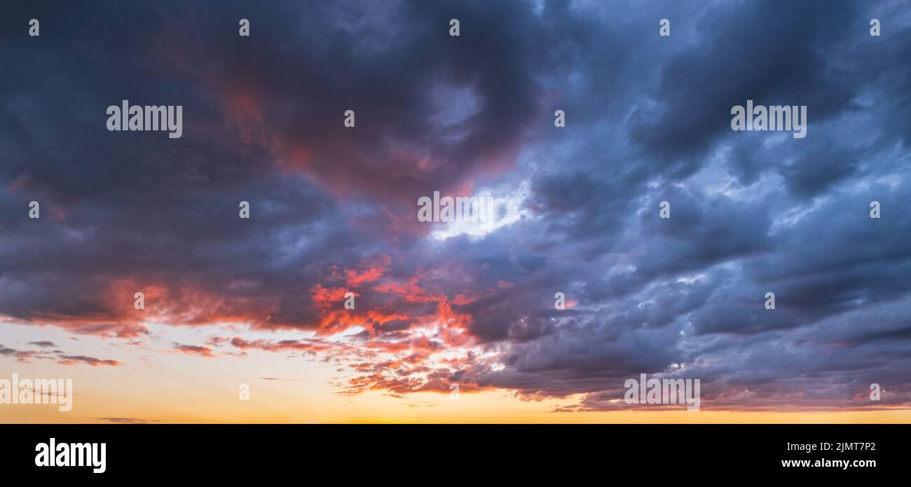 Clouds in evening dusk sky panoramic view. Climate, environment and weather concept sky background. Stock Photo