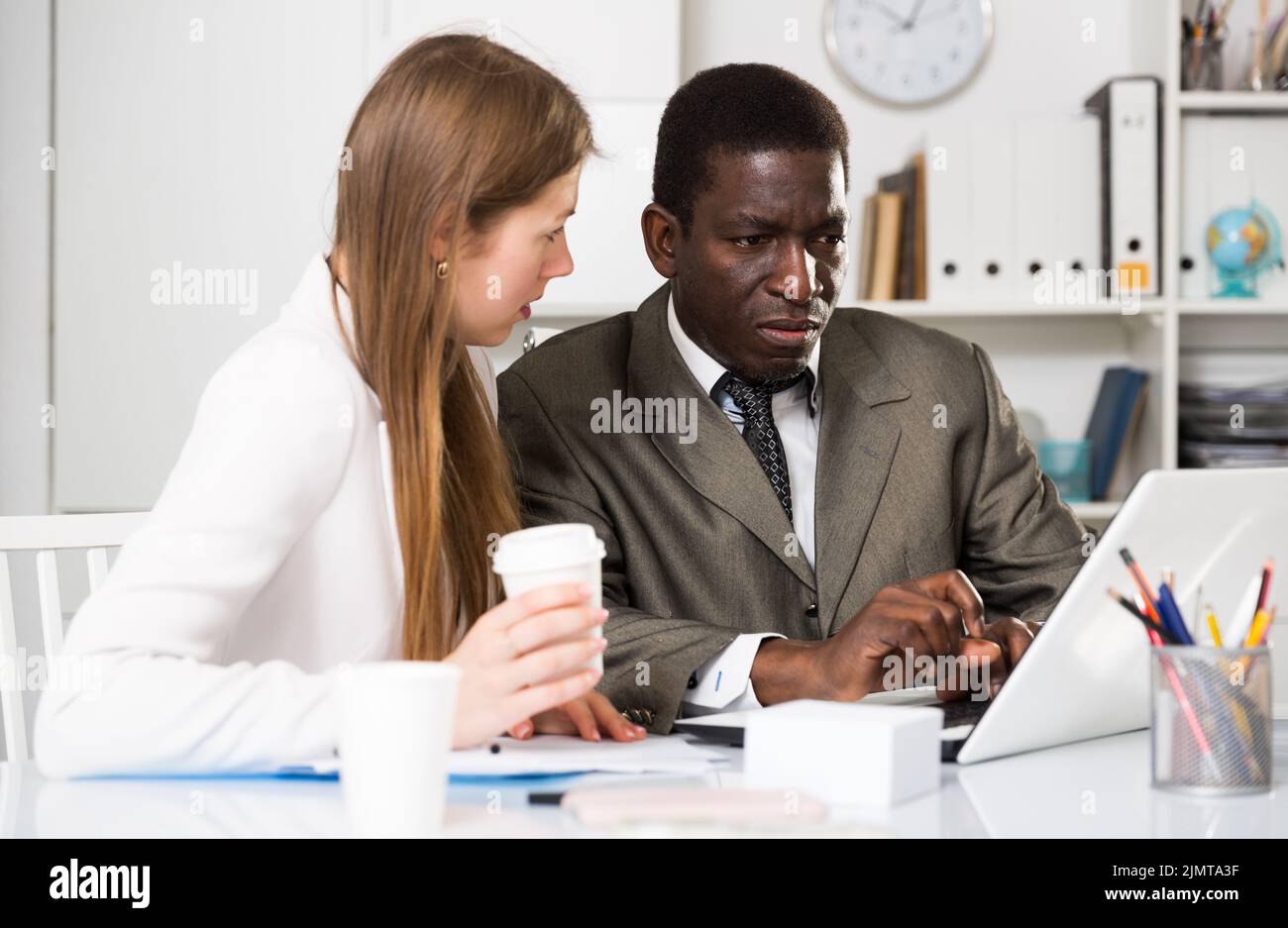 Focused coworkers working together Stock Photo - Alamy