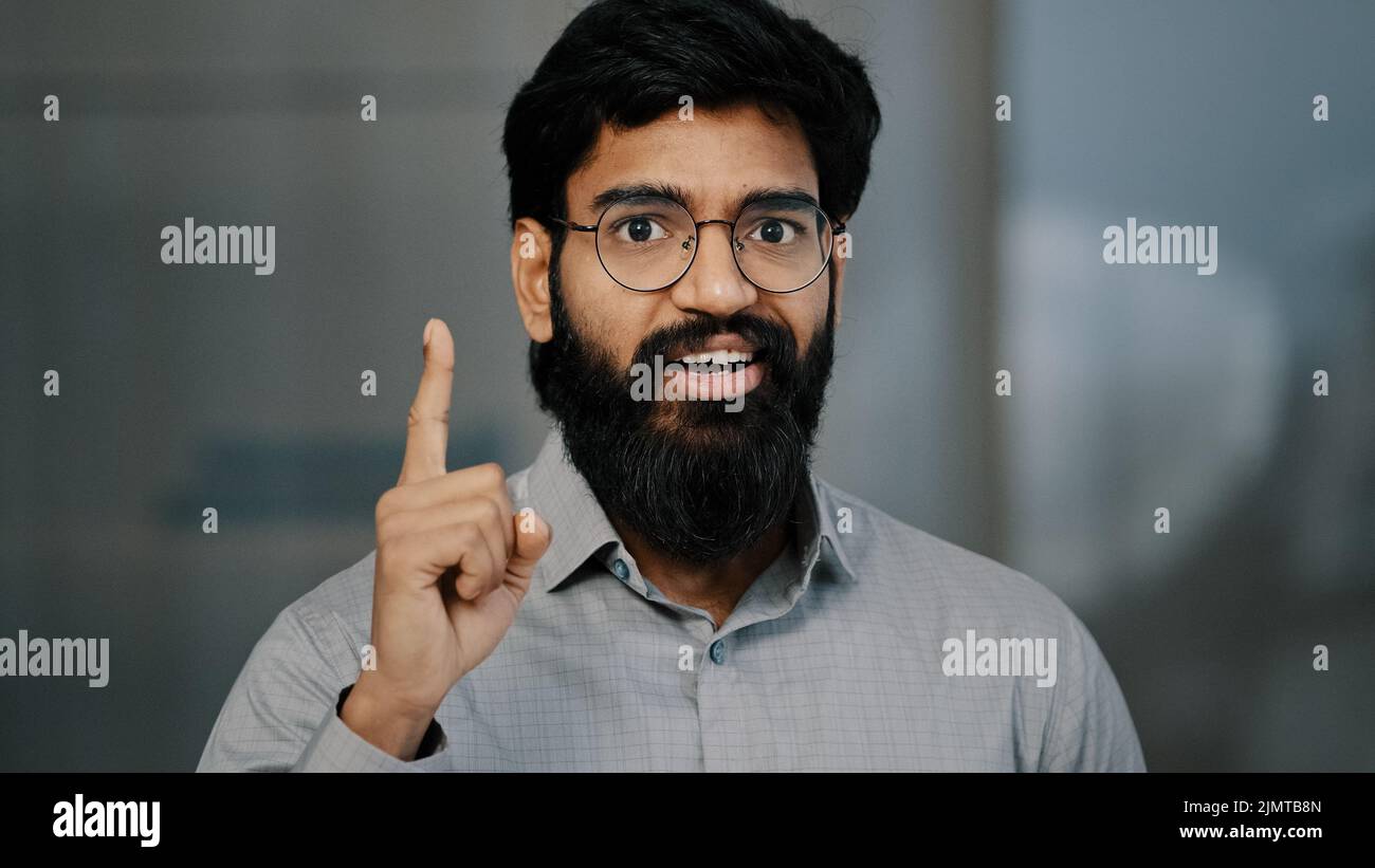 Close-up portrait arabian male pensive business man hold hand on chin concentrated think of solution issue deep in thoughts excited young eyeglasses Stock Photo