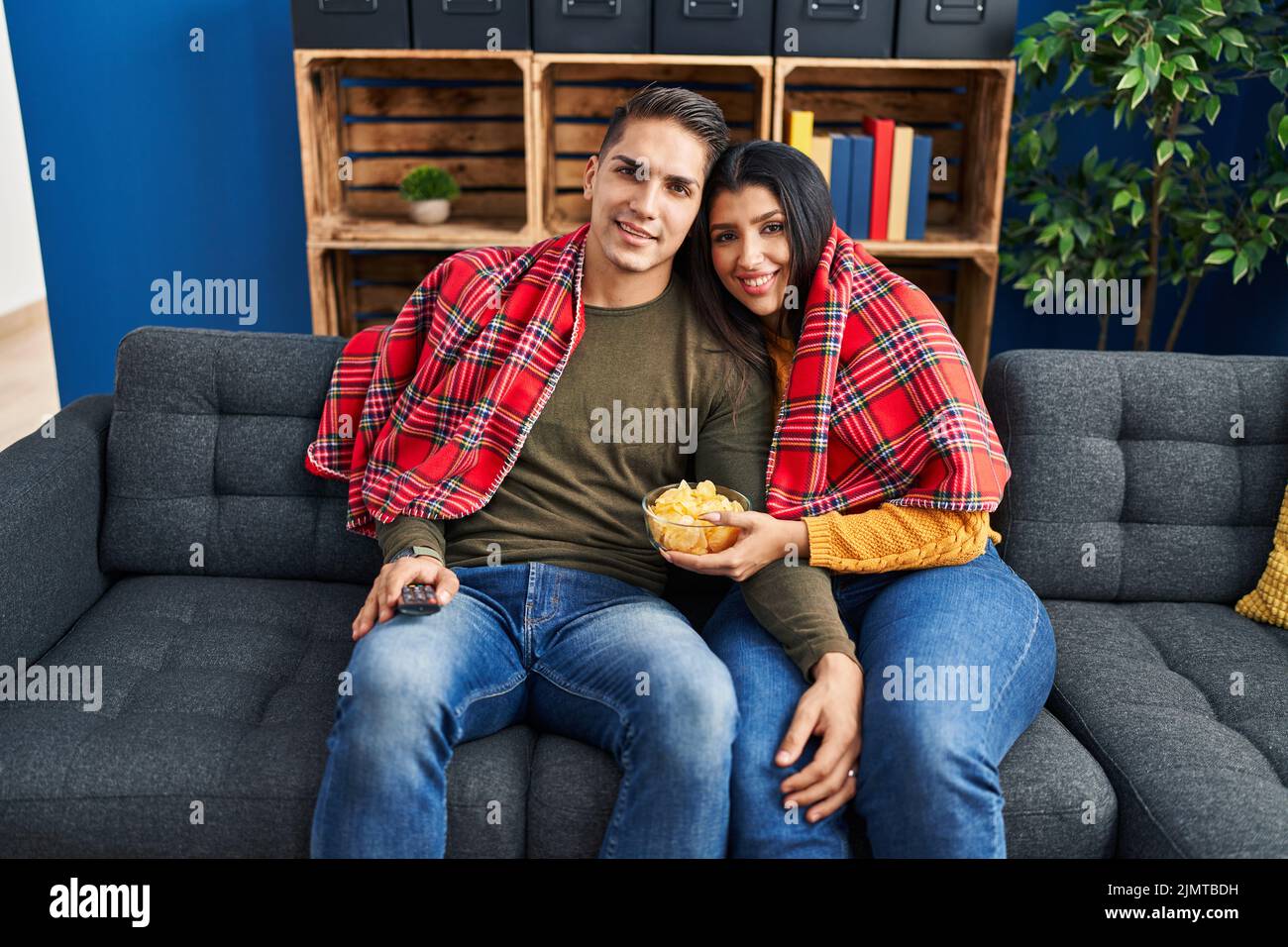 Man and woman couple hugging each other watching movie at home Stock ...