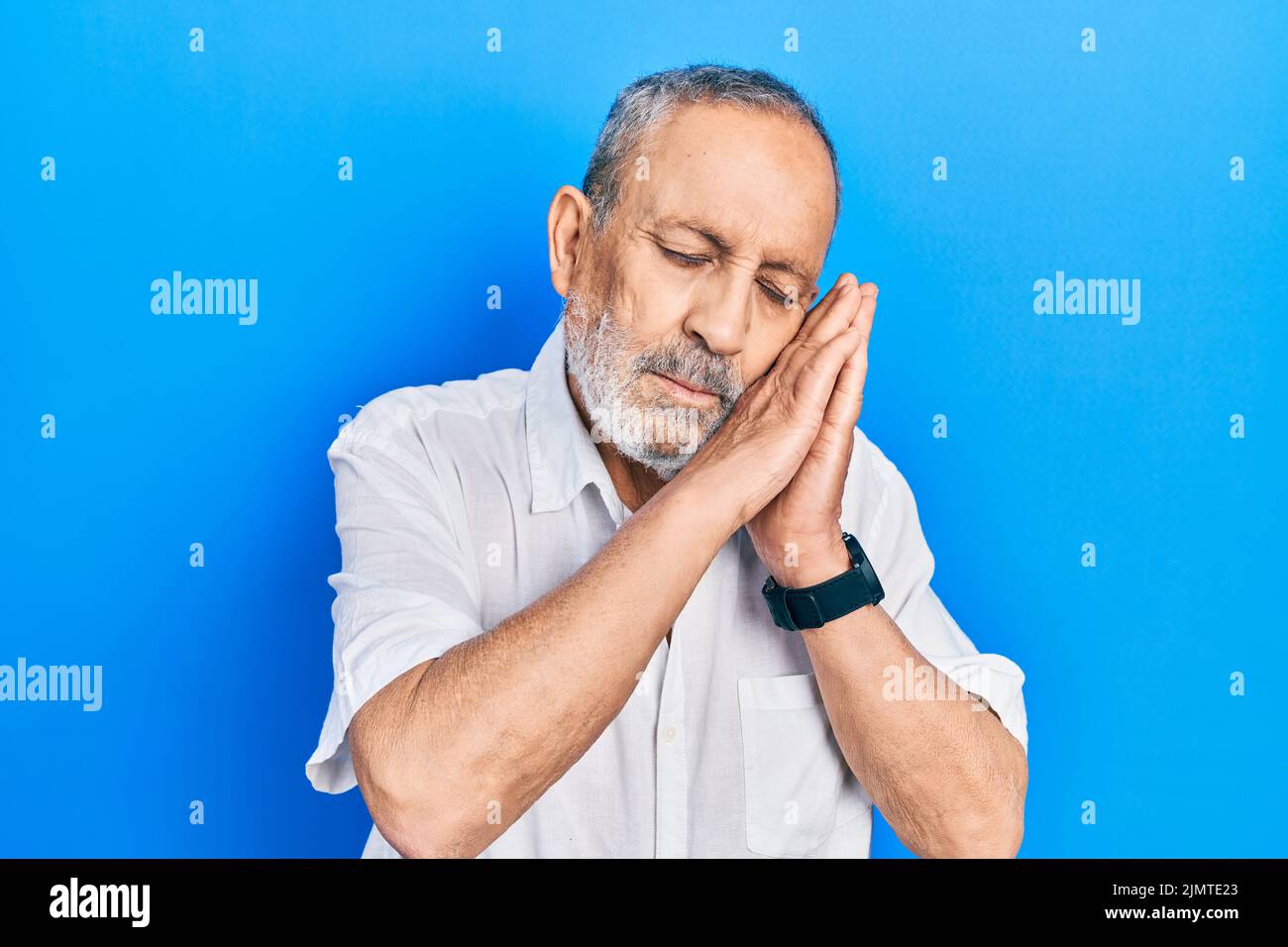 Handsome senior man with beard wearing casual white shirt sleeping ...