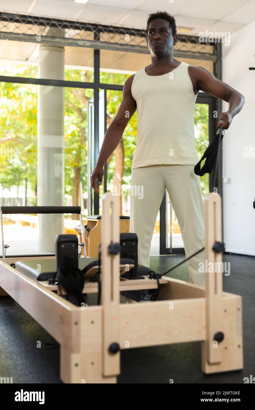 Mature Man Exercising On Pilates Reformer Short Box During Class In Fitness  Studio High-Res Stock Photo - Getty Images