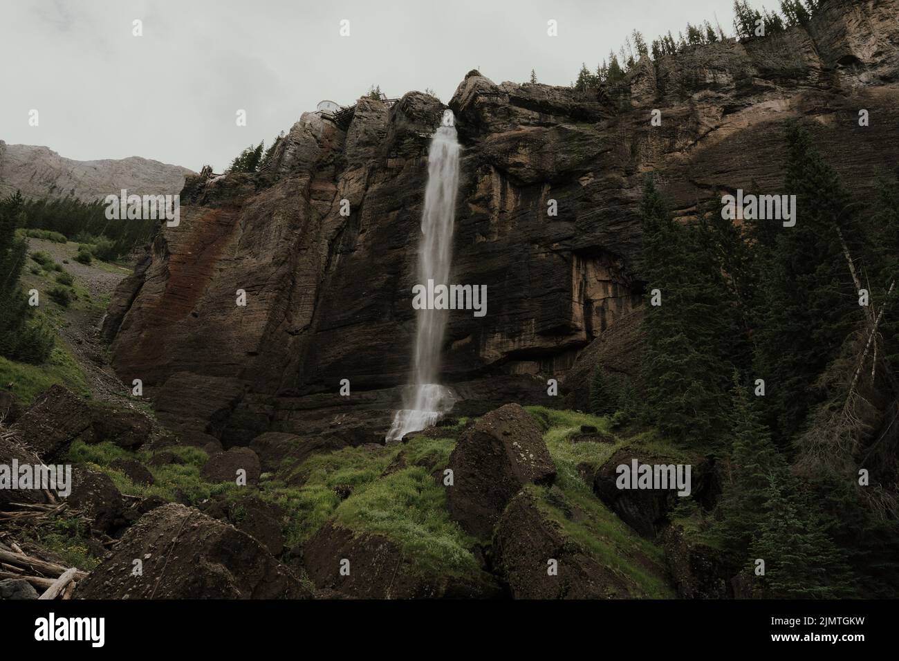 A beautiful scenery of a waterfall dropping from a rocky mountain on ...