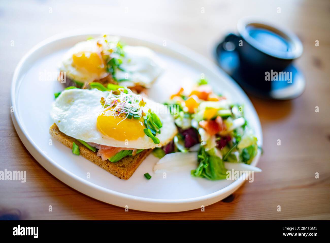 Breakfast with fried eggs on toasts on a restaurant table Stock Photo