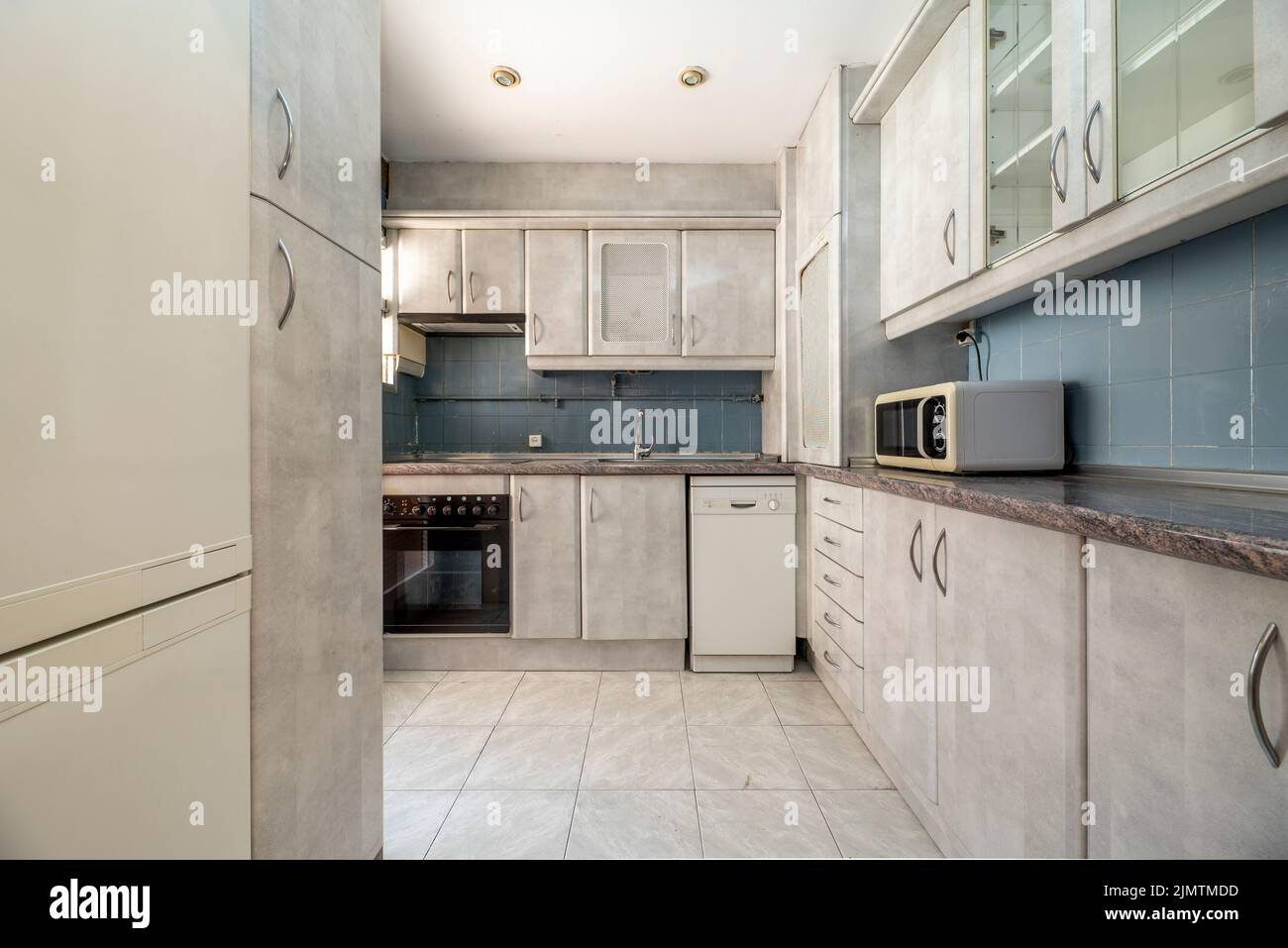 open plan kitchen with gray wood walk in closets stainless