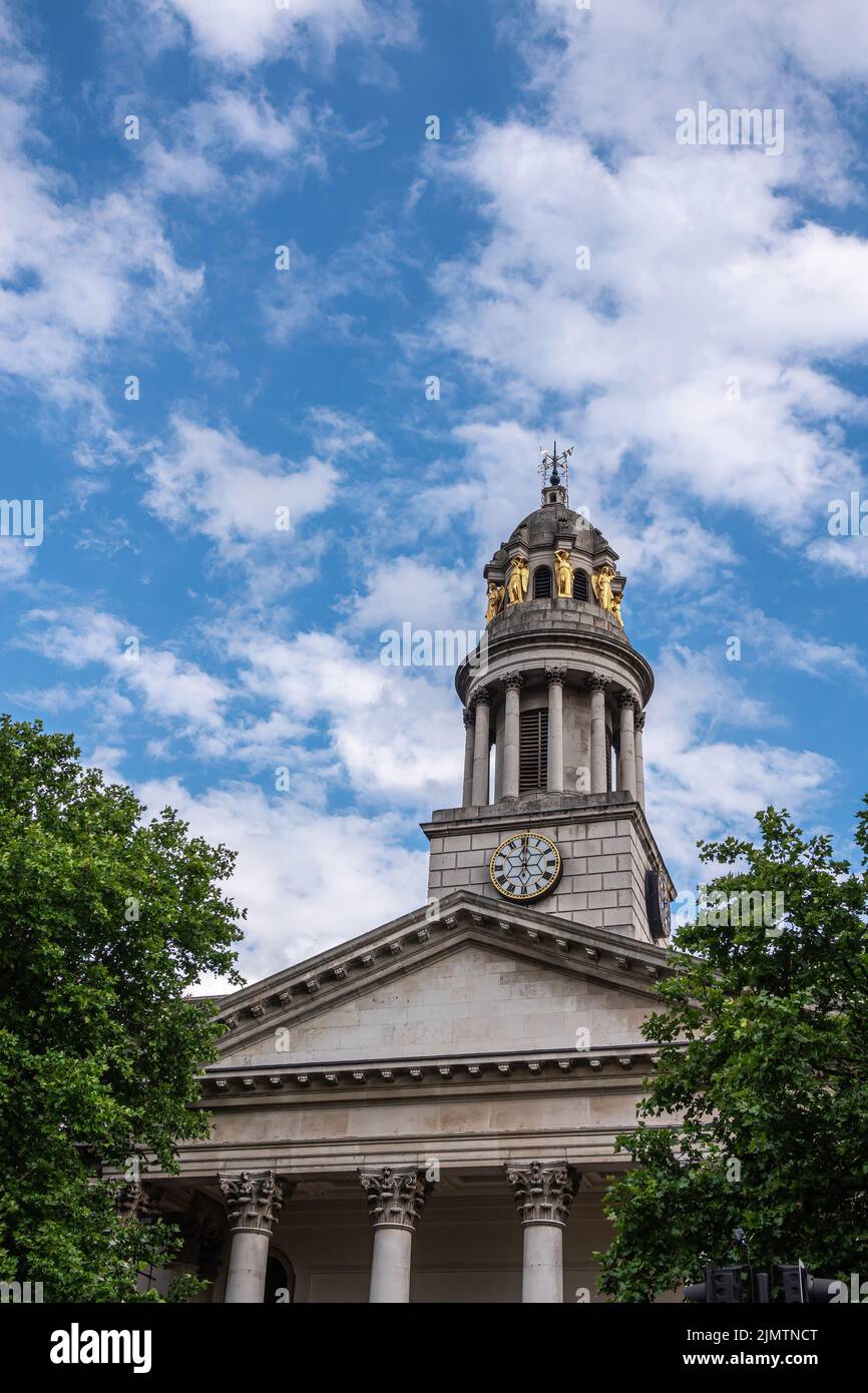 London, Great Britain - July 3, 2022: Closeup of clock tower with golden caryatid statues and pediment on columns of St. Marylebone Parish Church unde Stock Photo
