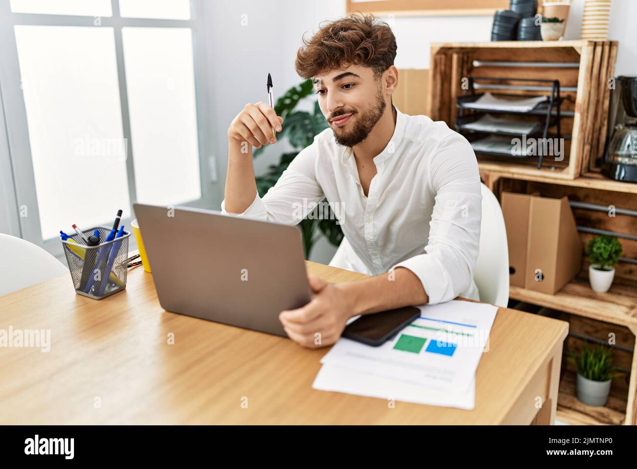 Young arab man using laptop working at office Stock Photo