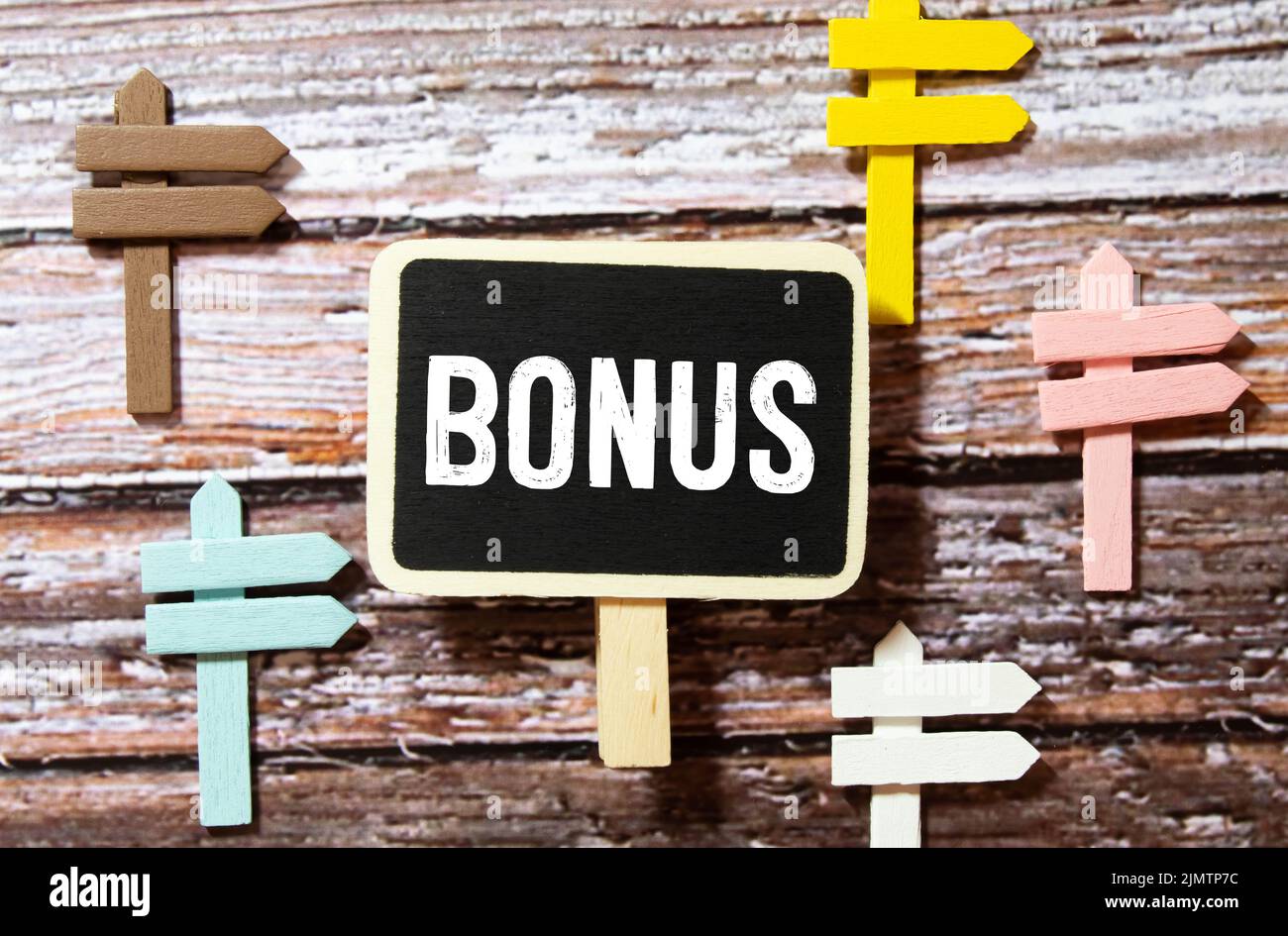 The word BONUS is written on notepad. The cubes are on the charts, cash is near. Stock Photo