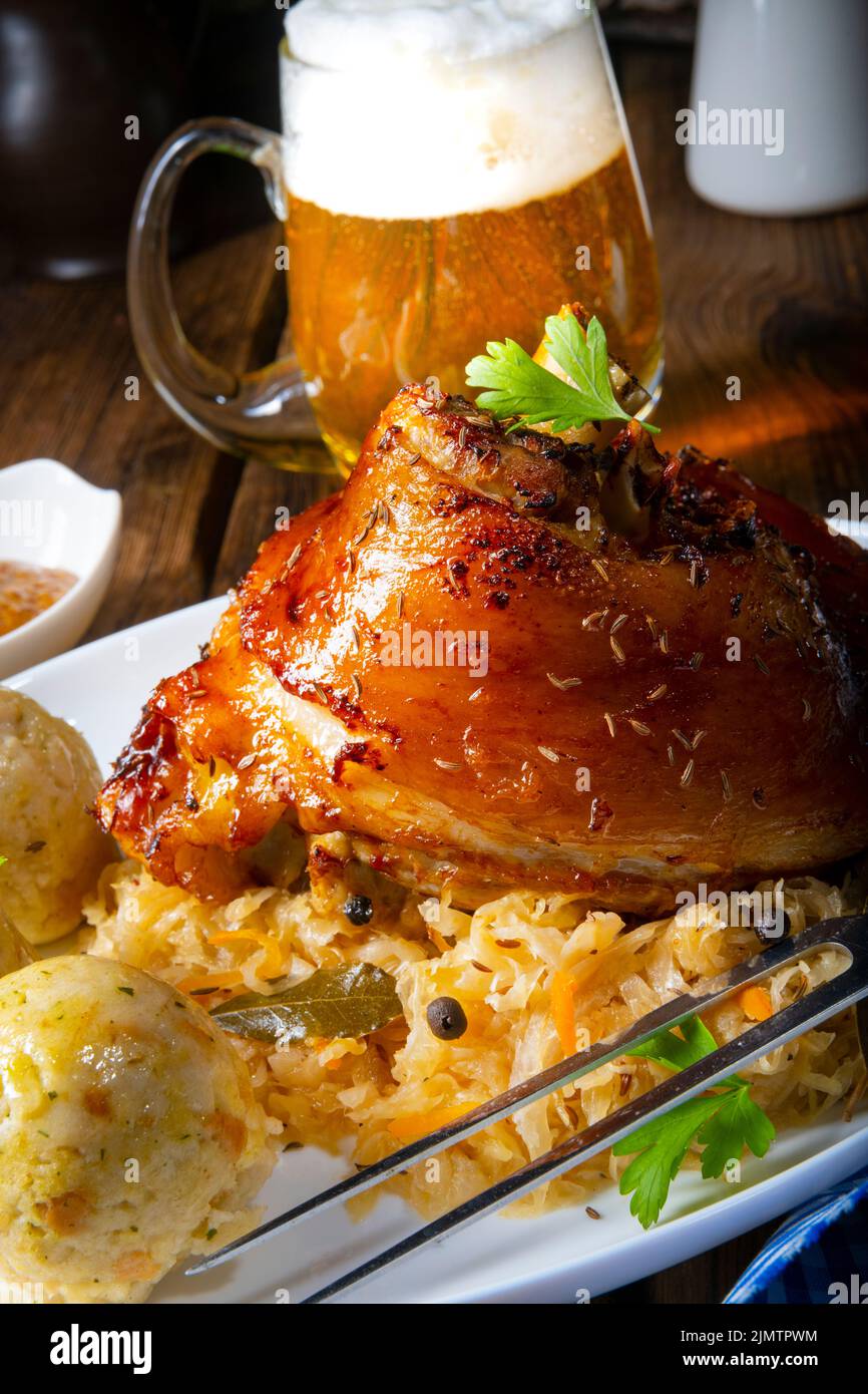 Pork knuckle with sauerkraut and sweet mustard Stock Photo Alamy