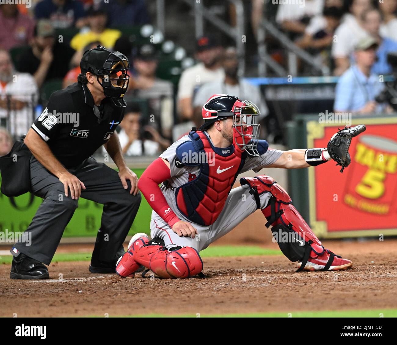 MLB umpire James Hoye (92) and Boston Red Sox catcher Kevin Plawecki (25) during the MLB game between the Boston Red Sox and the Houston Astros on Tue Stock Photo
