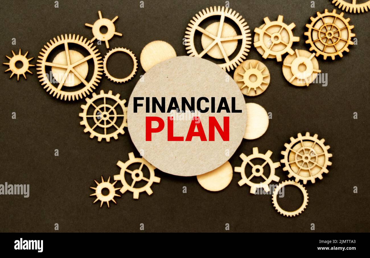 Financial plan inscription. Blank album paper with financial plan inscription for today on table with office items Stock Photo