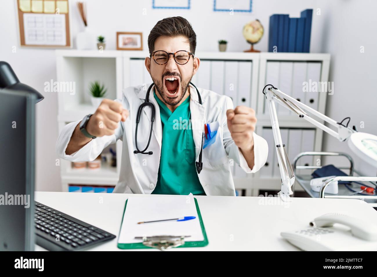 Young man with beard wearing doctor uniform and stethoscope at the