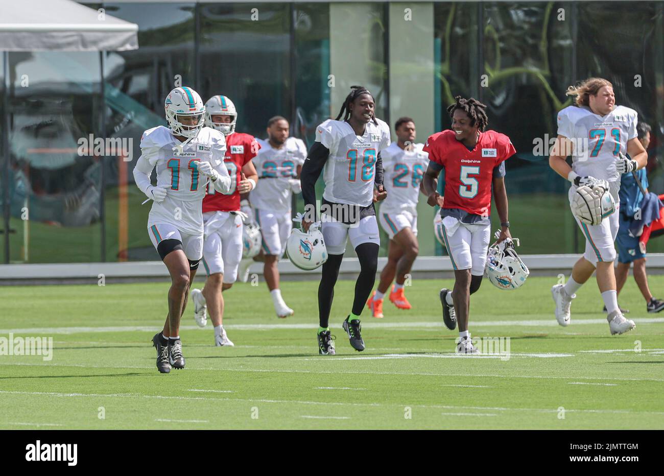 Miami. FL USA;  Miami Dolphins wide receivers Cedrick Wilson Jr. (11) and Preston Williams (18) run out to practice with new backup quarterback Teddy Stock Photo