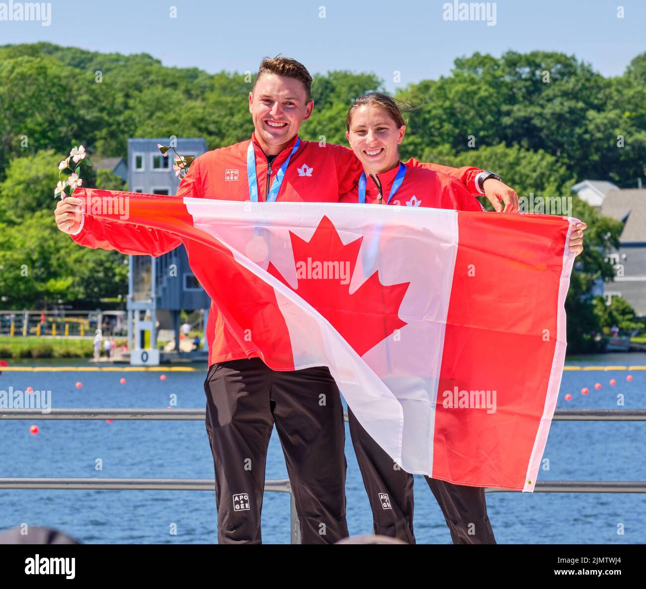 Dartmouth, Canada. August 7th, 2022. Gold Medalists and World Champion Connor Fitzpatrick and Katie Vincent from Canada receive their medal in the C2 Mix 500m event which they won in front of a loud home crowd. This would be the first of three world titles for Katie Vincent on the day. The 2022 ICF Canoe Sprint and Paracanoe World Championships takes place on Lake Banook in Dartmouth (Halifax). Credit: meanderingemu/Alamy Live News Stock Photo
