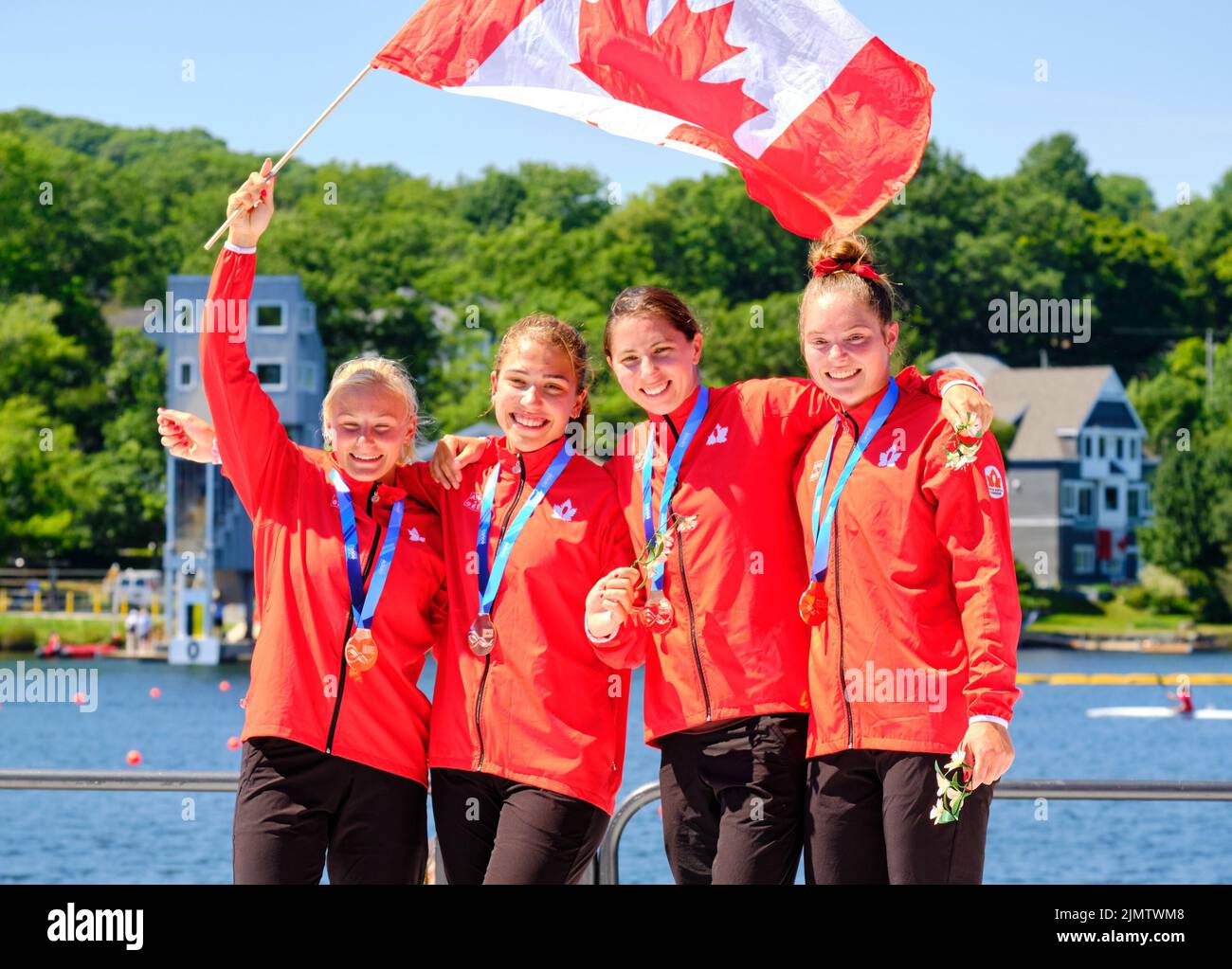 Dartmouth, Canada. August 7th, 2022. Gold Medalists and World Sophia Jensen, Sloan Mackenzie, Katie Vincent and Julia Osende from Canada celebrate their medal in the C4 Women 500m event which they won in front of a loud home crowd. The 2022 ICF Canoe Sprint and Paracanoe World Championships takes place on Lake Banook in Dartmouth (Halifax). Credit: meanderingemu/Alamy Live News Stock Photo