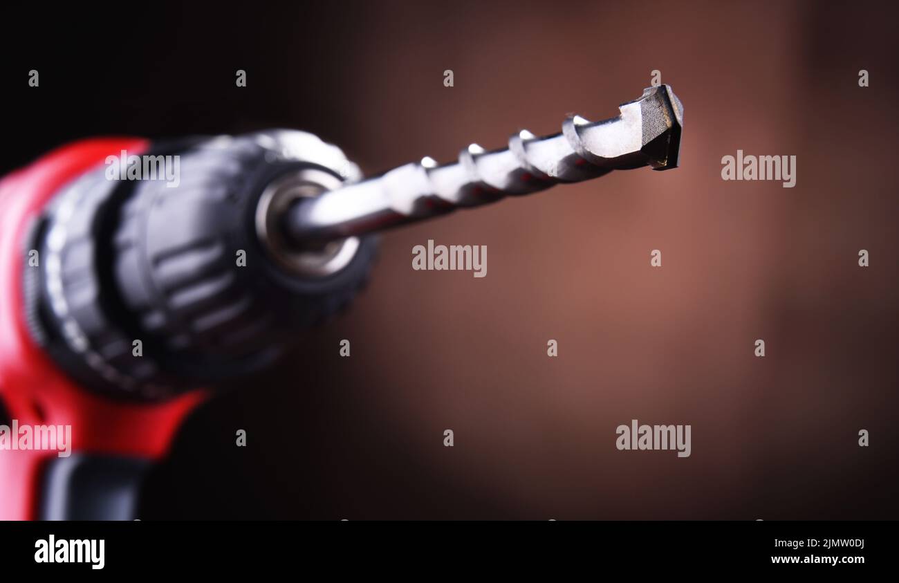 Composition with a cordless drill also working as a screw gun Stock Photo