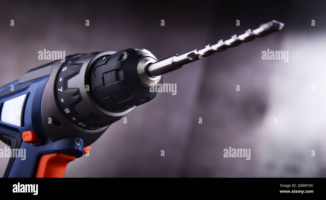 Composition with a cordless drill also working as a screw gun Stock Photo