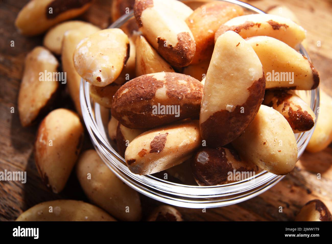 Composition with a bowl of shelled brazil nuts. Delicacies Stock Photo