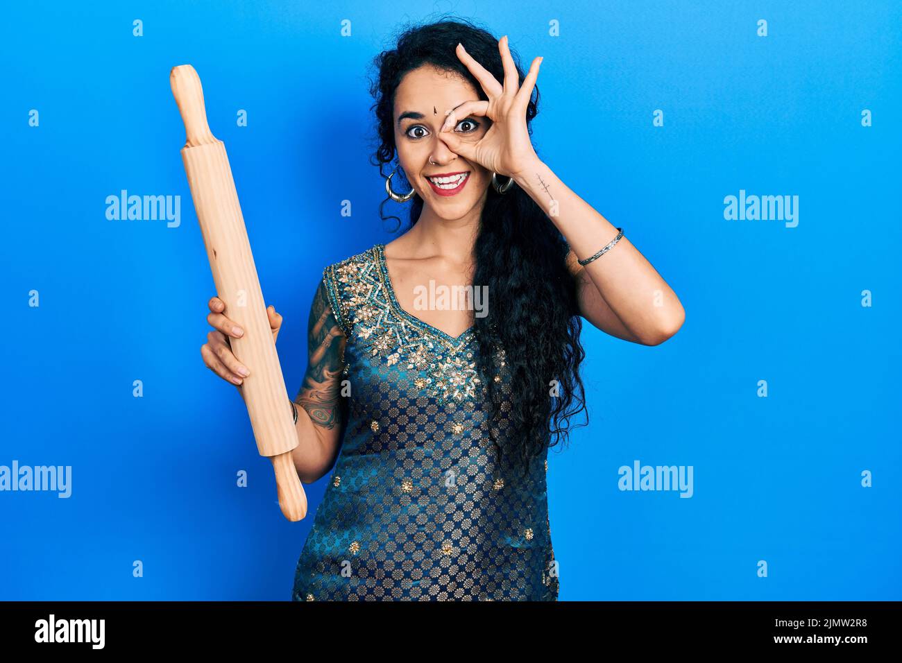Young woman wearing bindi and traditional kurta dress holding kneading ...