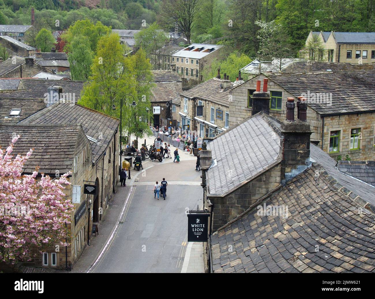 Panoramic view of the town of hebden bridge with people outside pubs and bars in the town square Stock Photo