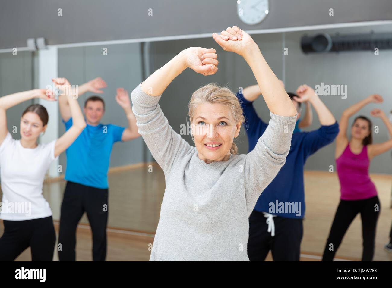 Mature woman practicing vigorous dance Stock Photo