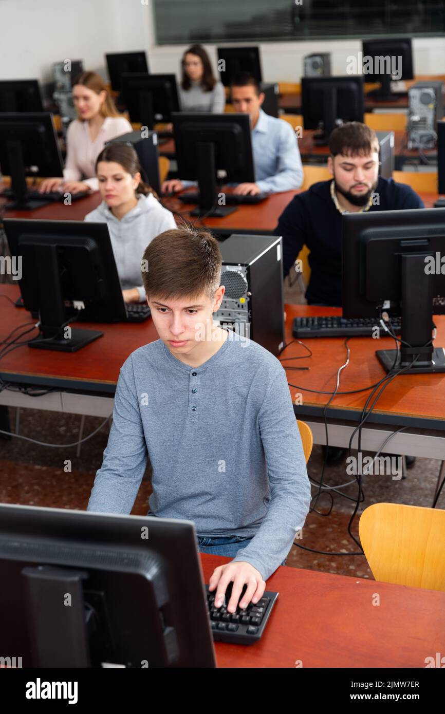 Computer lessons for adults in classroom Stock Photo - Alamy