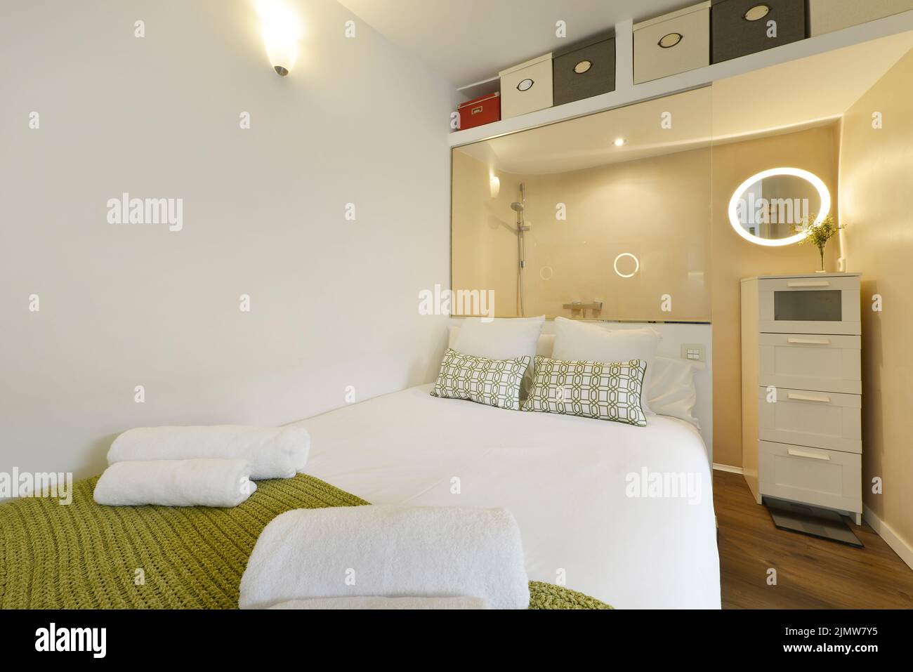 Bedroom with double bed with headboard leaning against the wall of the