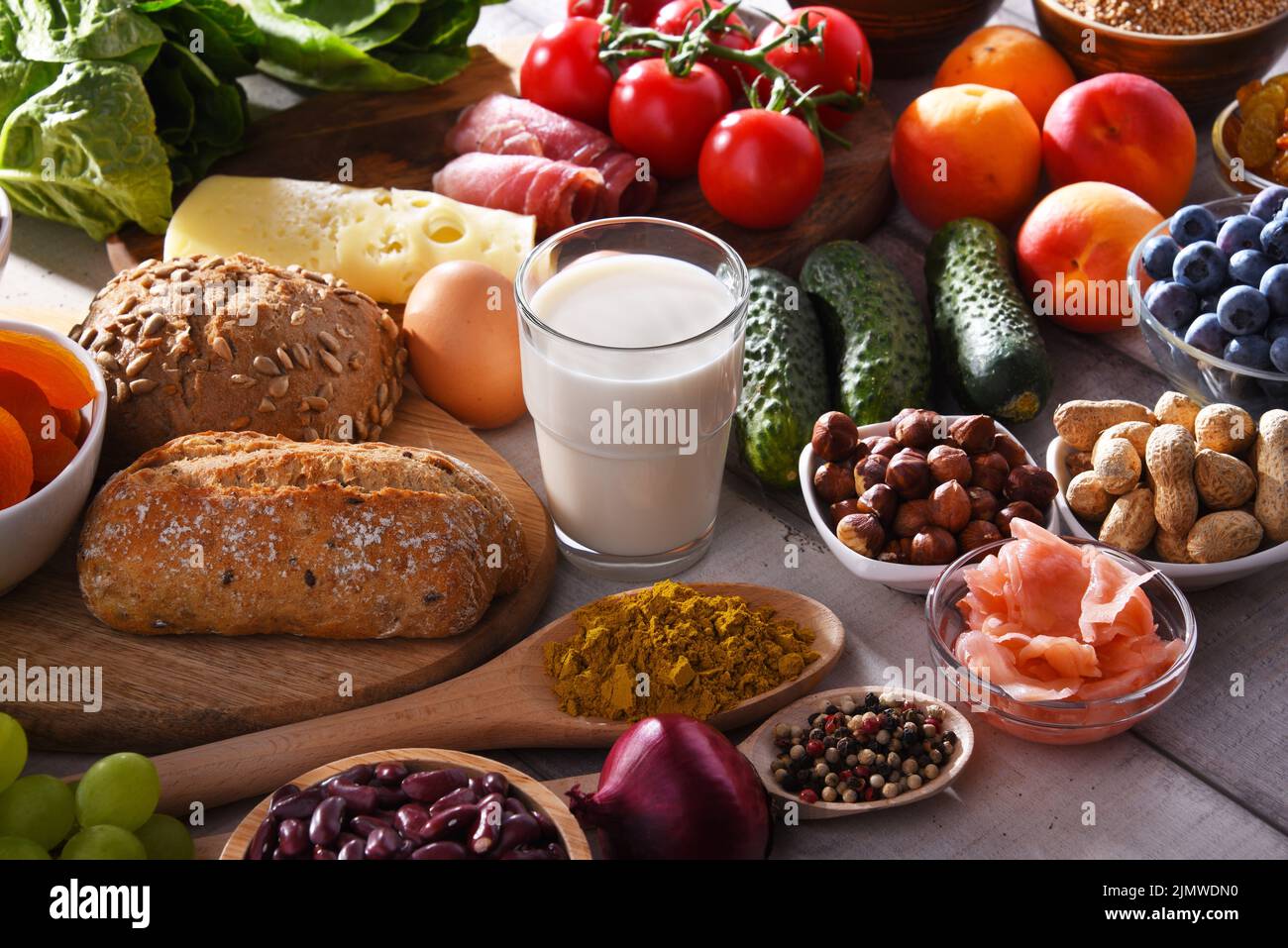 Composition with assorted organic food products on wooden kitchen table ...
