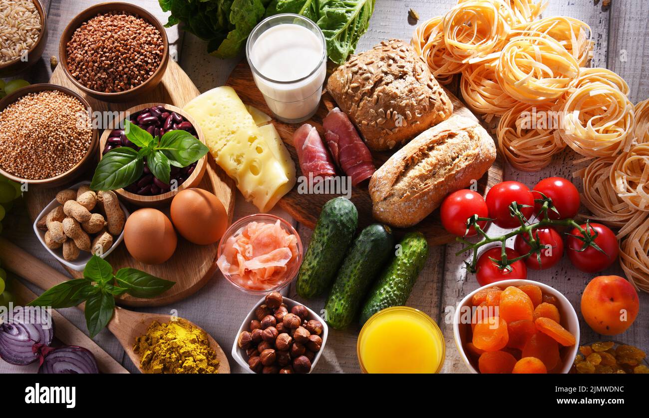 Composition with assorted organic food products on wooden kitchen table ...