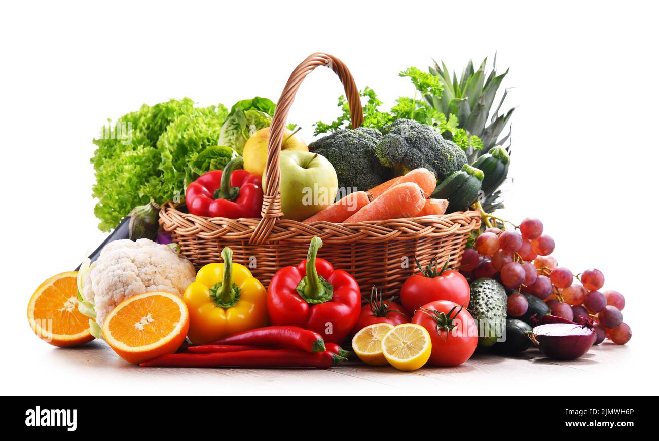 Assorted organic vegetables and fruits in wicker basket isolated on ...