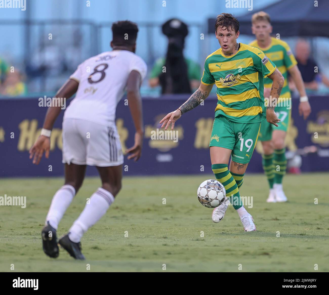 St. Petersburg, FL: Tampa Bay Rowdies forward Jake LaCava (19)dribbles the ball and looks to pass around Detroit City midfielder  Abdoulaye Drop (8) d Stock Photo