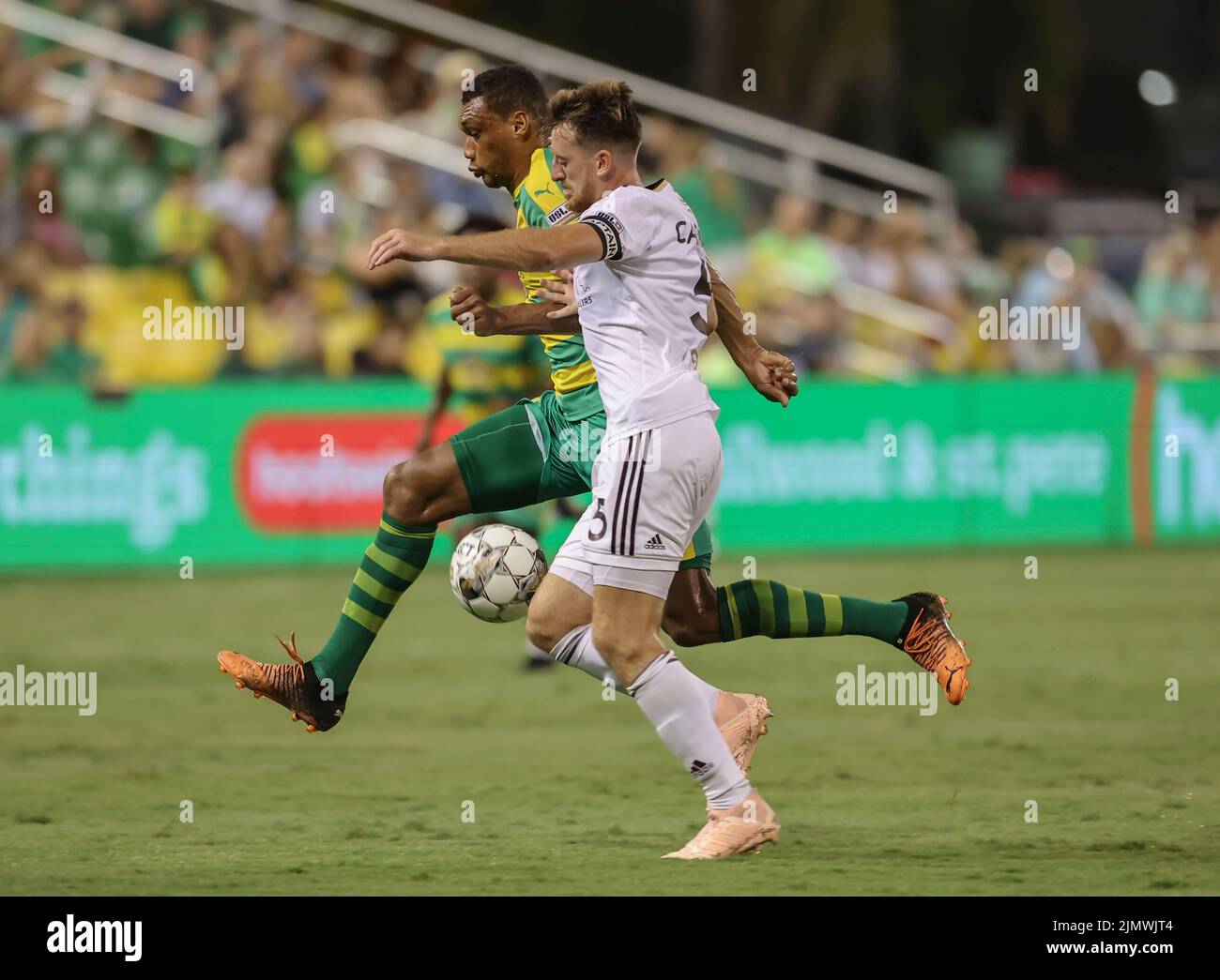 St. Petersburg, FL: Detroit City Defender Matt Lewis (15) and Tampa Bay Rowdies forward Steevan Dos Santos (10) vie for possession of the ball during Stock Photo
