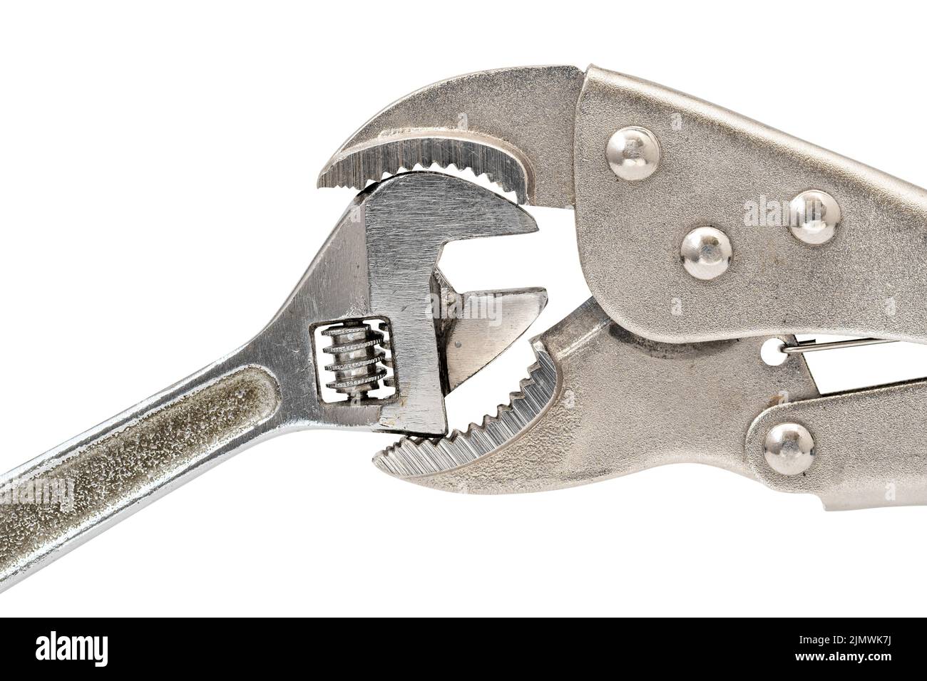 Big adjustable wrench squeezing small adjustable wrench Stock Photo Alamy