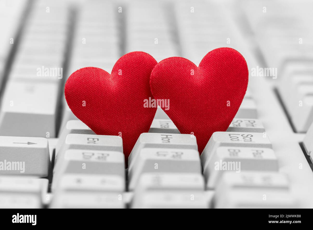 Small red hearts on keyboard Stock Photo