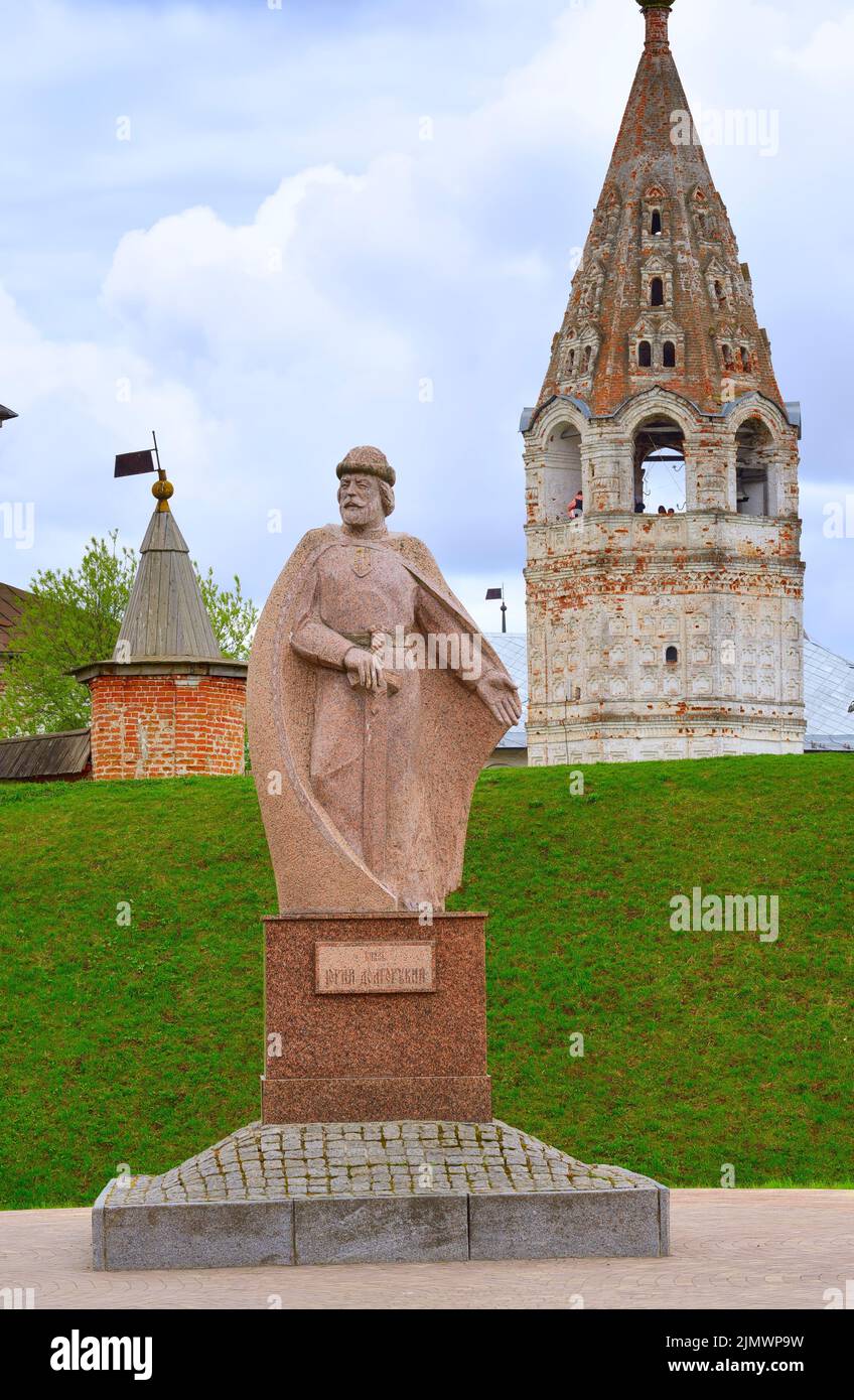 Yuryev-Polsky, Russia, 05.08.2022. Monument to Prince Yuri Dolgoruky. Granite sculpture on the background of the domes of the Archangel Michael Cathed Stock Photo