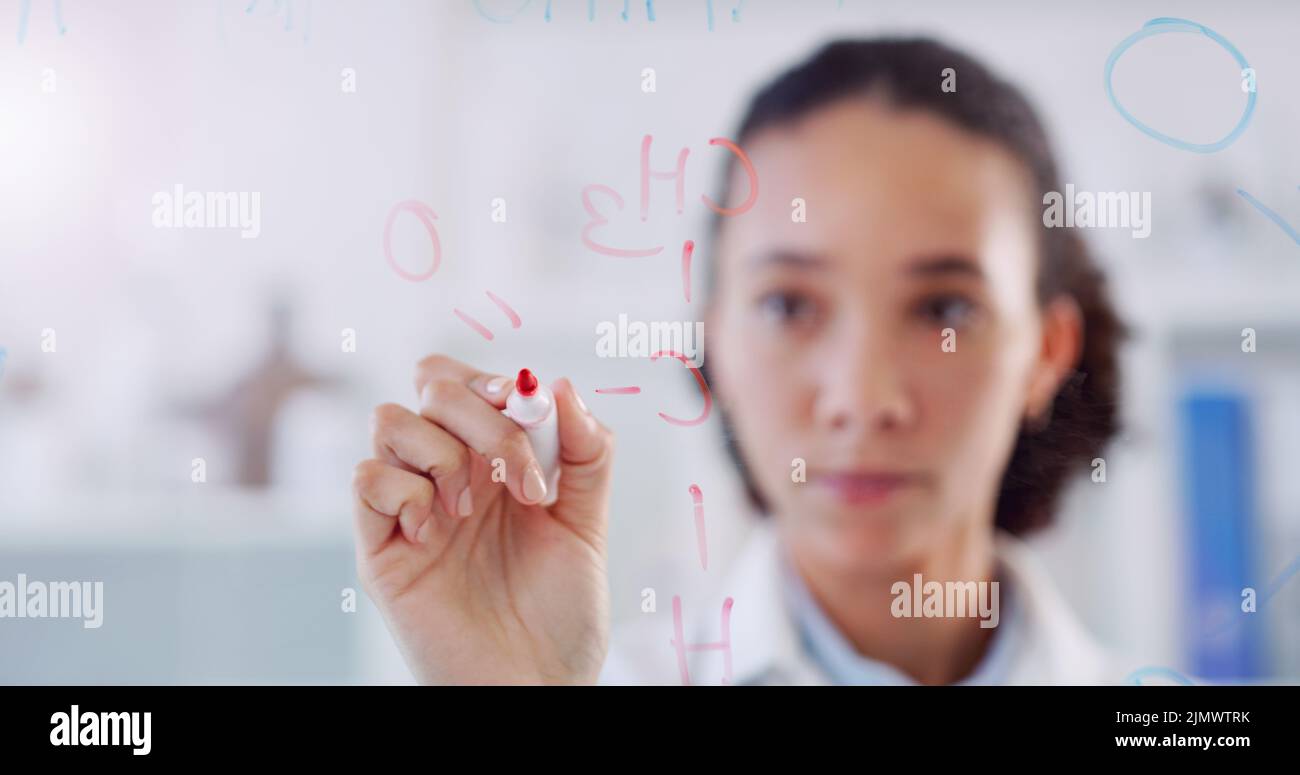 Every detail adds up. Shot young scientist drawing molecular structures