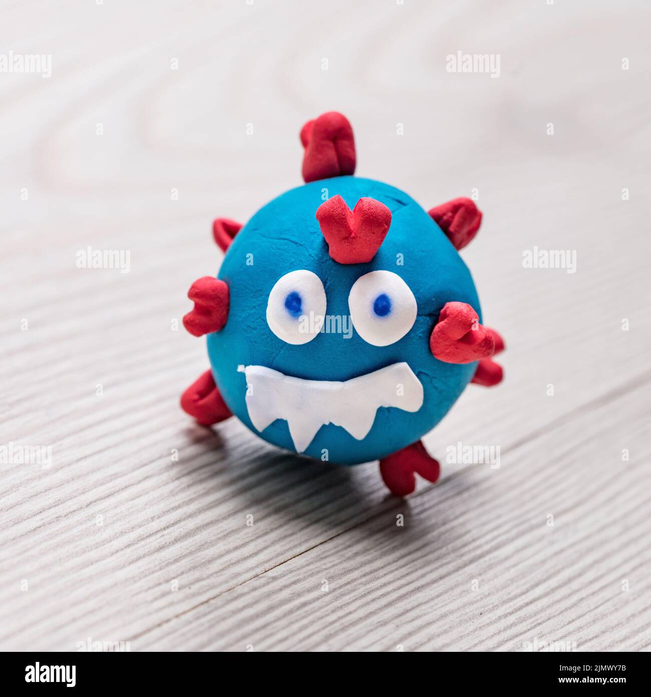 puppet depicting a small COVID-19 virus monster, smiling evilly and ready to strike... until its total defeat. Stock Photo
