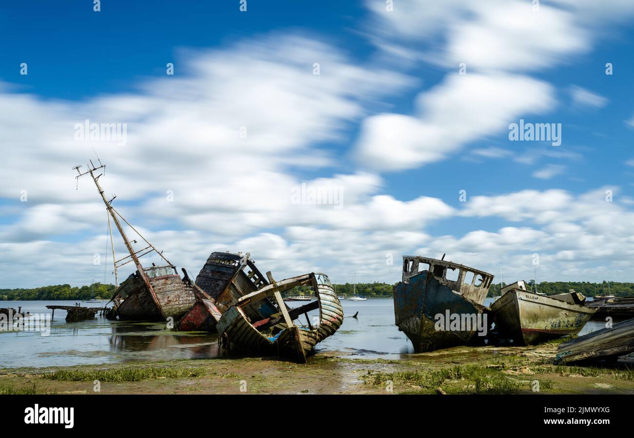 View of the boat graveyard at Pin Mill on the River Orwell in Suffolk at low tide Stock Photo