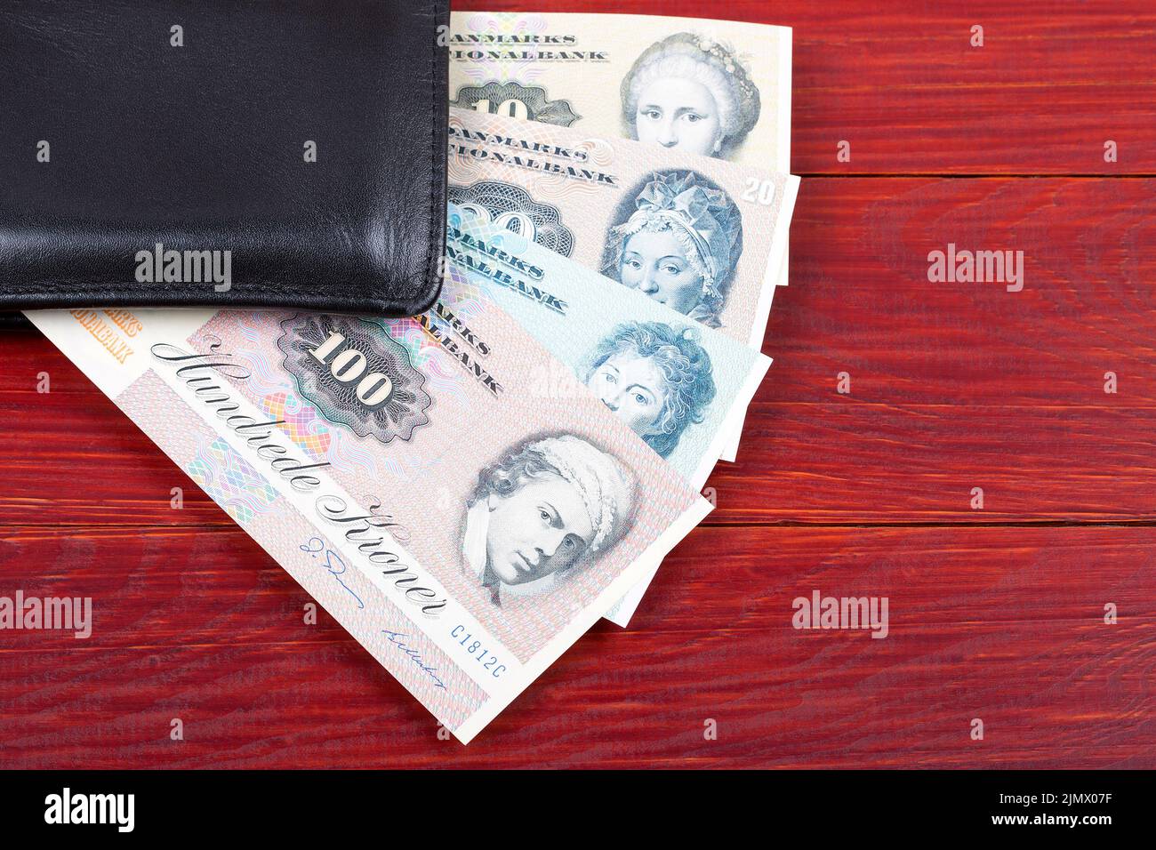 Old money from Denmark in the black wallet Stock Photo