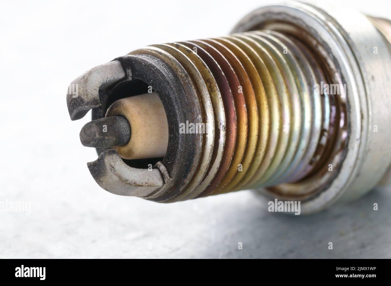 Closeup photo of old used spark plug for internal combustion engine. Space for text Stock Photo