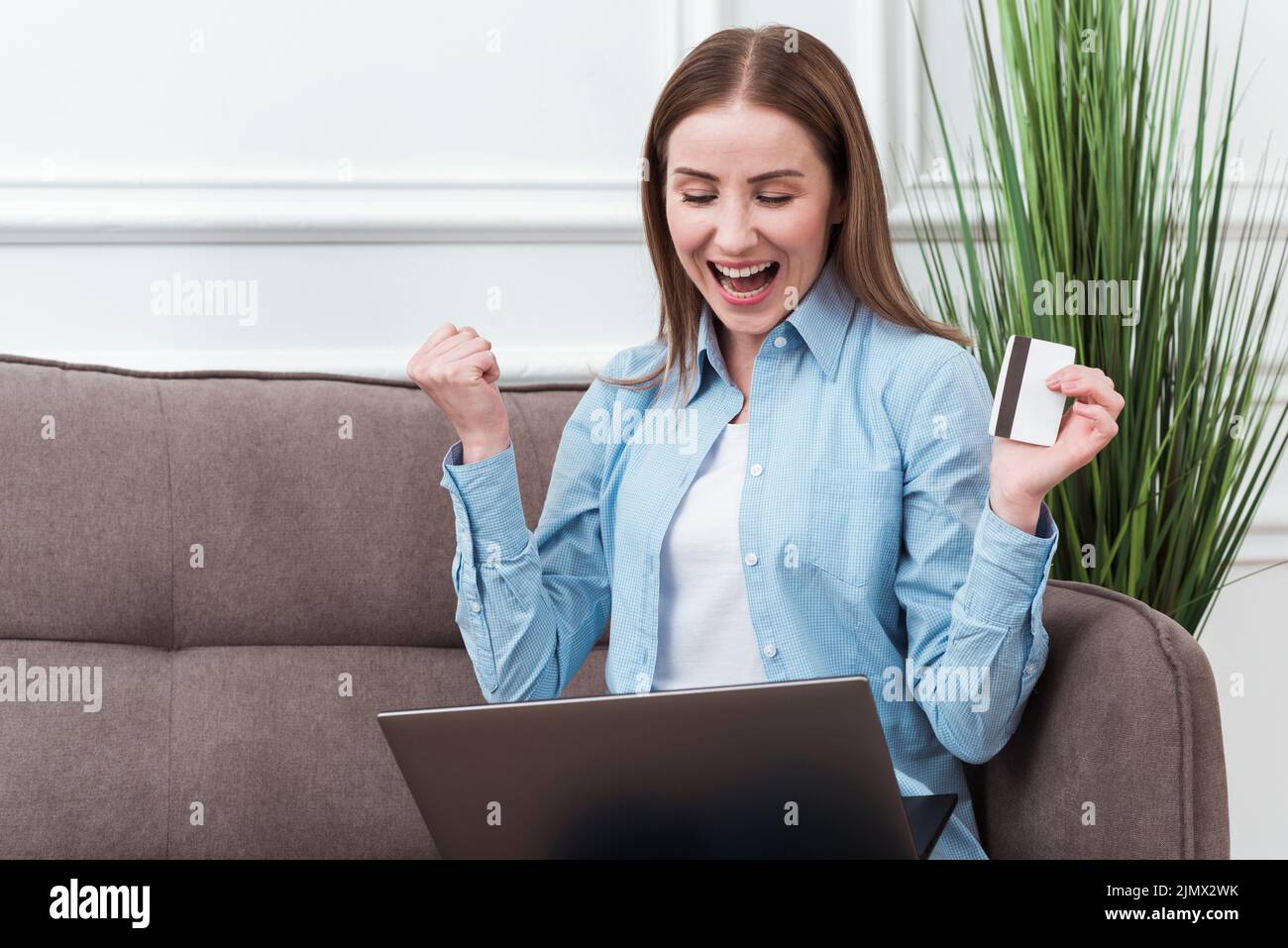 Woman being happy about ordering online Stock Photo