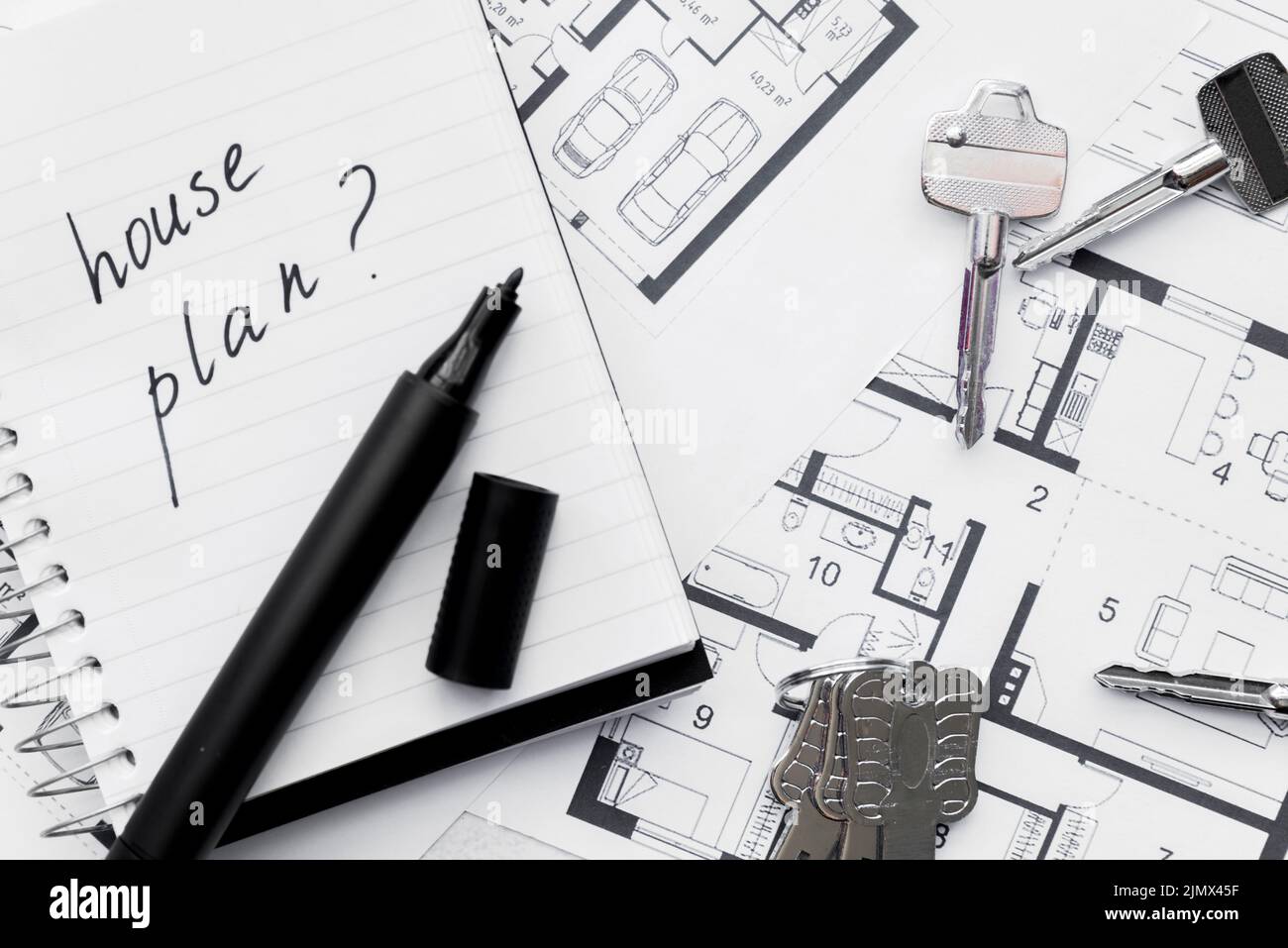 House plan with question mark sign written notebook with felt tip pen ...