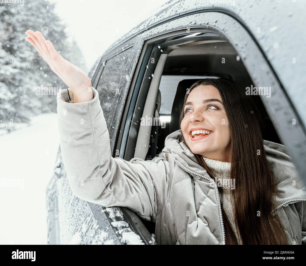Front view smiley woman car while road trip Stock Photo