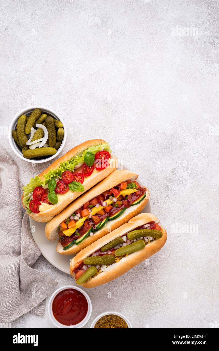 Flat lay delicious hot dogs with vegetables Stock Photo