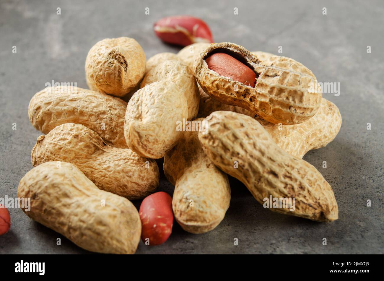 Peanut Ripe Ripe organic Peanuts in shell on stone table. Healthy eating concept ...
