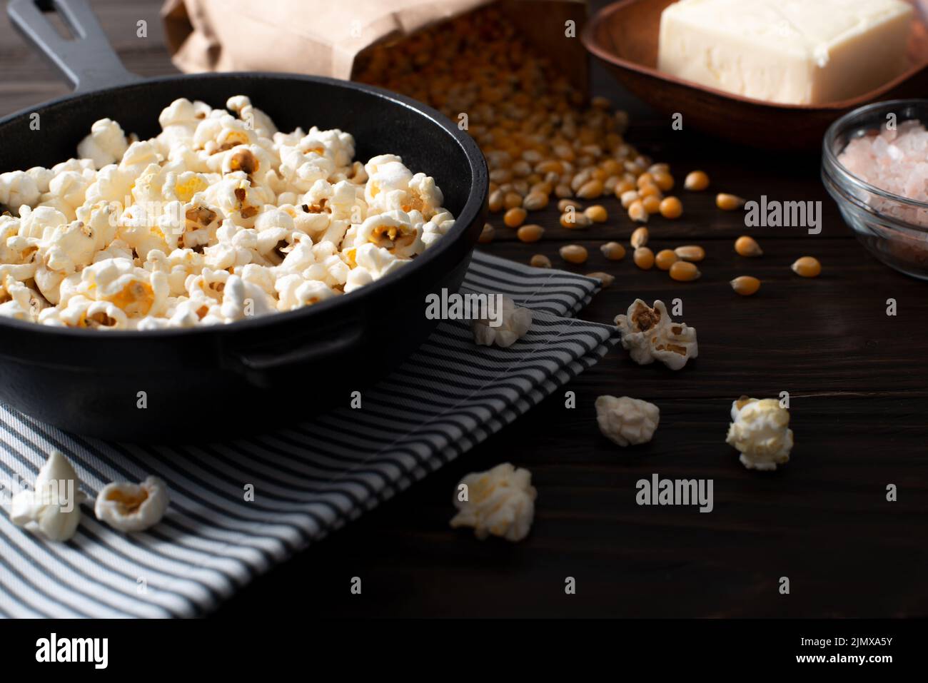 Popcorn in cast iron skillet with butter aside Stock Photo Alamy