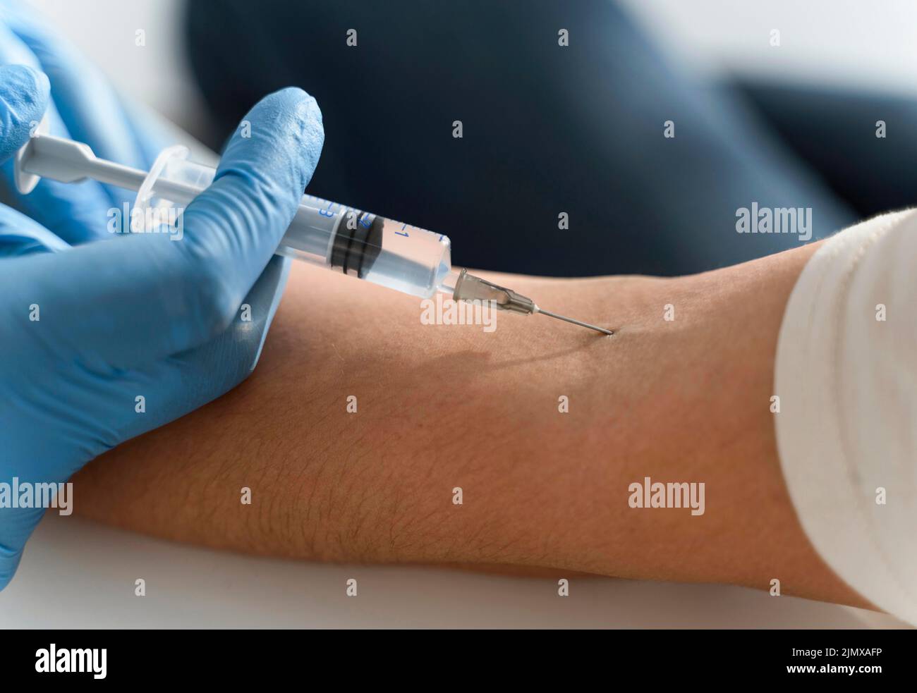 Doctor injecting vaccine woman s arm Stock Photo