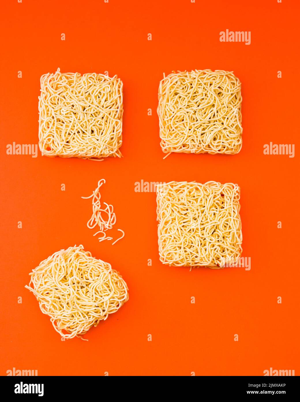 Dried instant noodle blocks arranged orange backdrop Stock Photo - Alamy