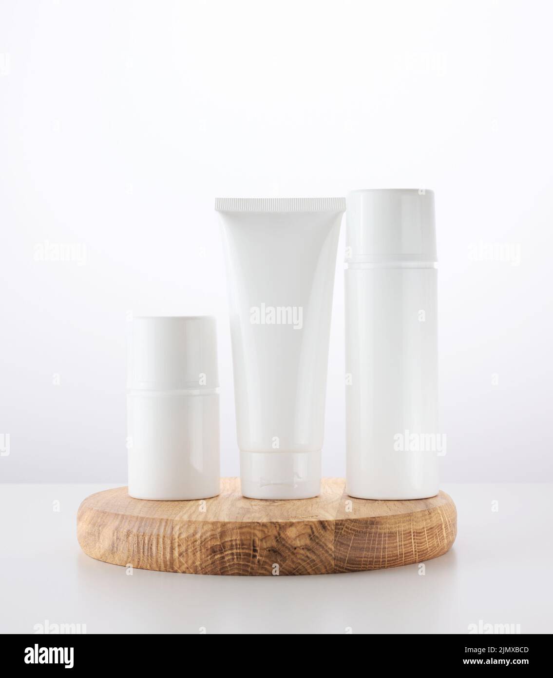 Bottle, empty white plastic tubes for cosmetics. Packaging for cream, gel, serum Stock Photo
